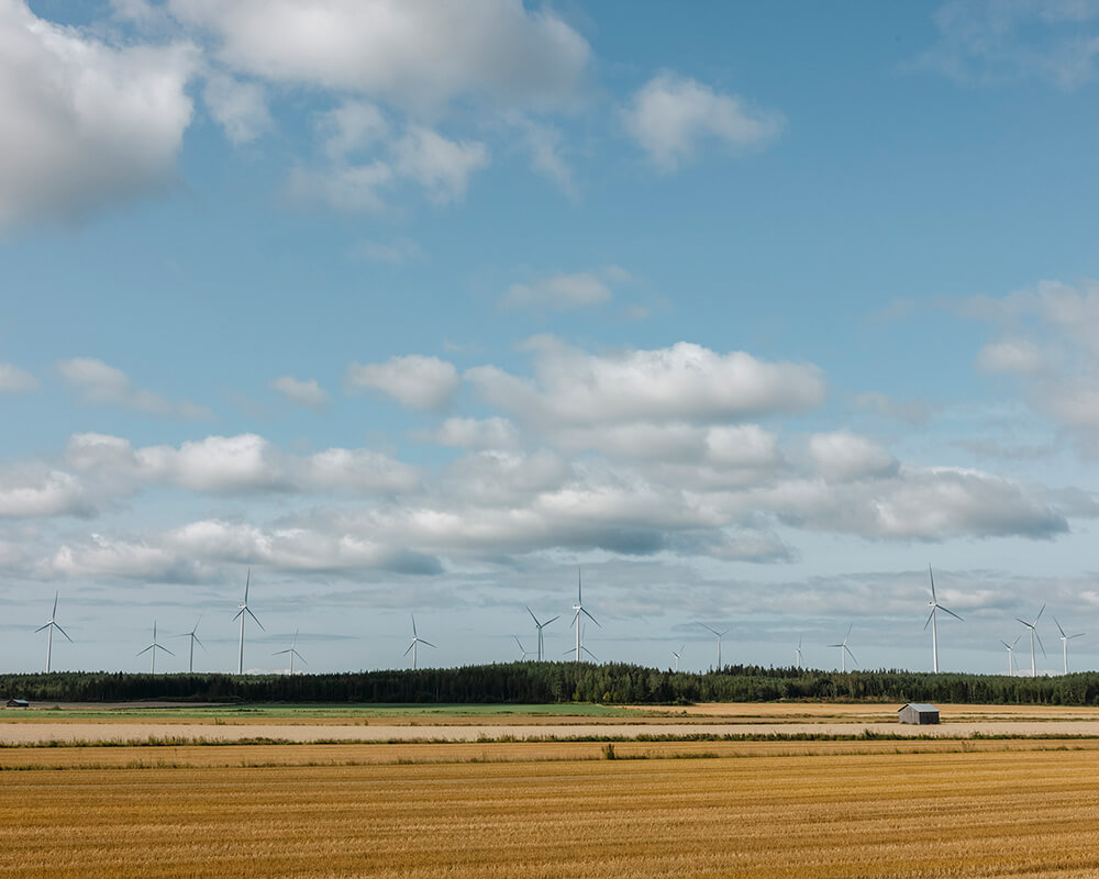 Wind turbines and a field in Finland
